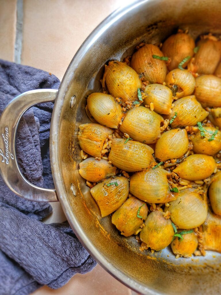 pan filled with huice, yummy greek onions stuffed with minced meat